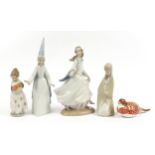 Four Lladro porcelain figurines and a Royal Crown Derby Imari porcelain bird paperweight, the