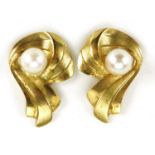 Pair of unmarked 9ct gold pearl stud earrings, 1.4cm high, 1.1g