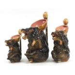 Graduated set of three Majolica style brown bear jugs, the largest 33cm high