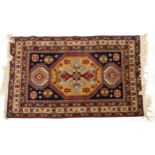 Rectangular Middle Eastern red and blue ground rug having an all over geometric design, 200cm x