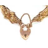 9ct rose gold love heart padlock on a yellow metal gate bracelet, 18cm in length, total weight 27.6g