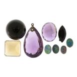 Collection of loose semi precious stones including amethyst, opals and citrine, the largest 2.8cm