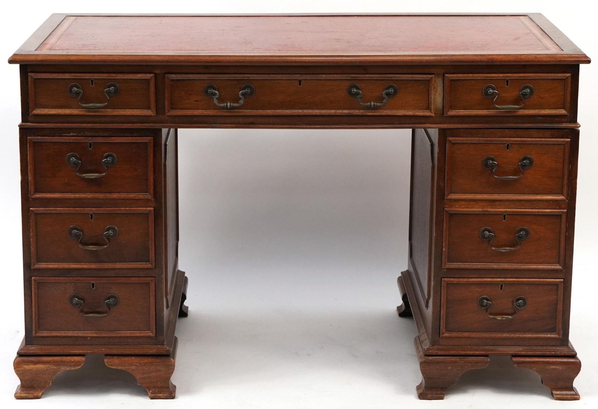 Mahogany nine drawer twin pedestal desk with red tooled leather top, 78cm H x 122cm W x 61cm D