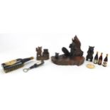 Objects including Black Forest bear carvings and Guinness memorabilia, the largest 23.5cm wide