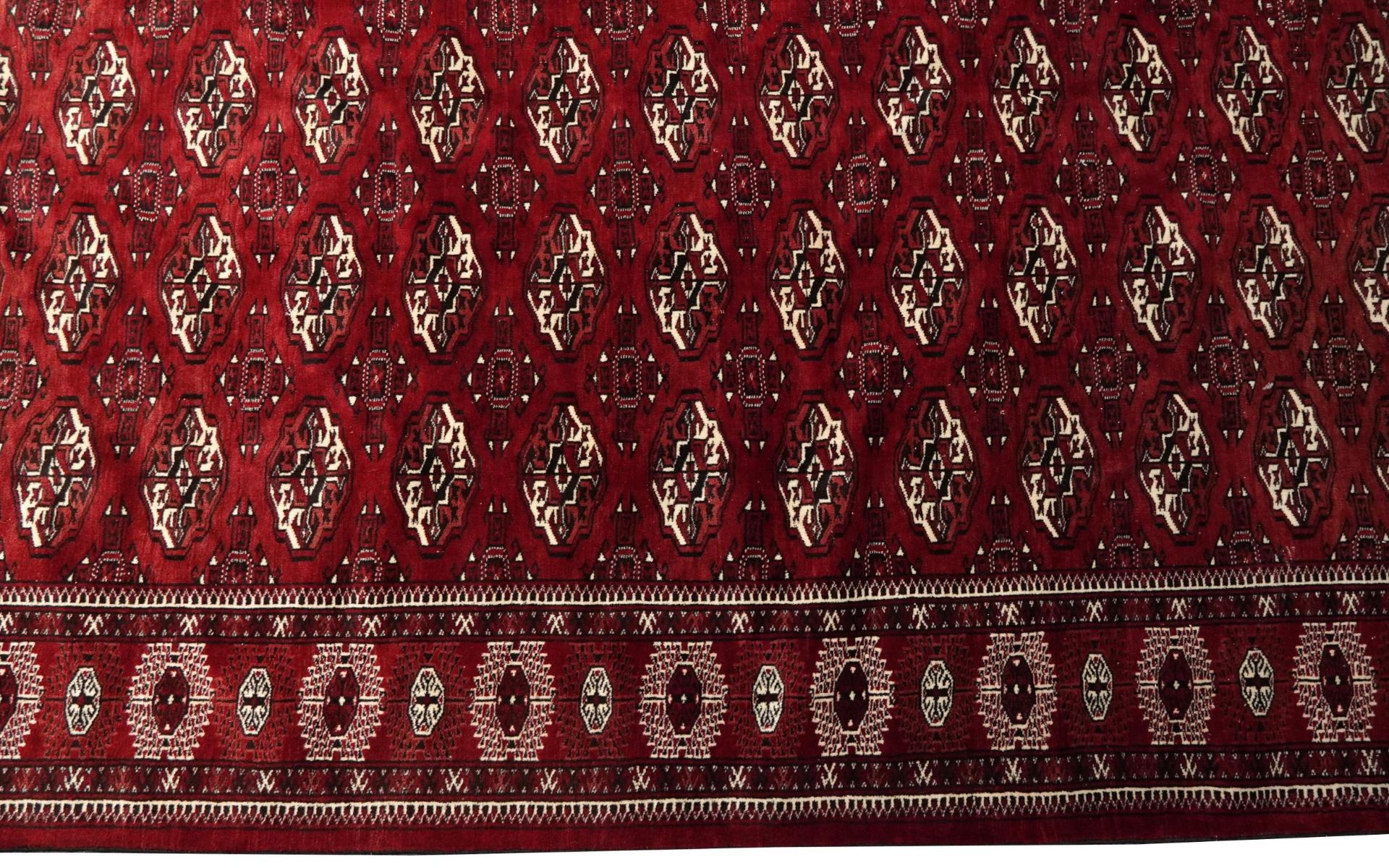 Rectangular Persian Turkmen red ground carpet having an all over geometric design, 345cm x 215cm - Image 6 of 8