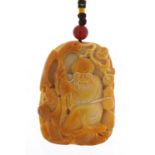 Chinese hardstone pendant carved with an elder holding a staff on cord, the pendant 6.5cm high
