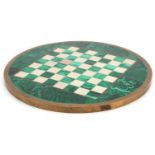 Circular malachite, alabaster and brass chess board, 32.5cm in diameter