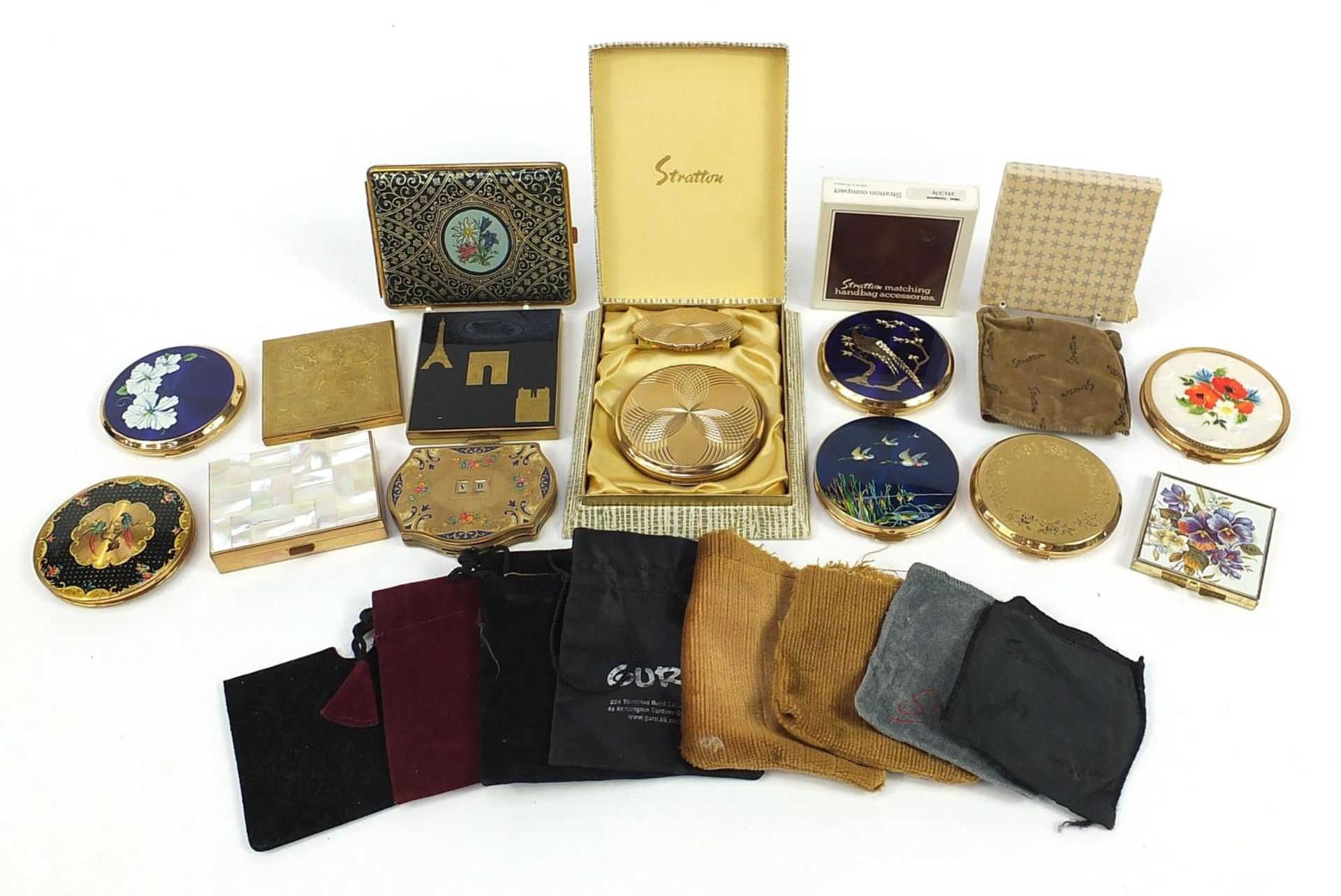 Twelve vintage ladies powder compacts and a tooled leather cigarette case, some enamelled