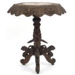 Burmese side table with octagonal top profusely carved with wild animals amongst flowers, with