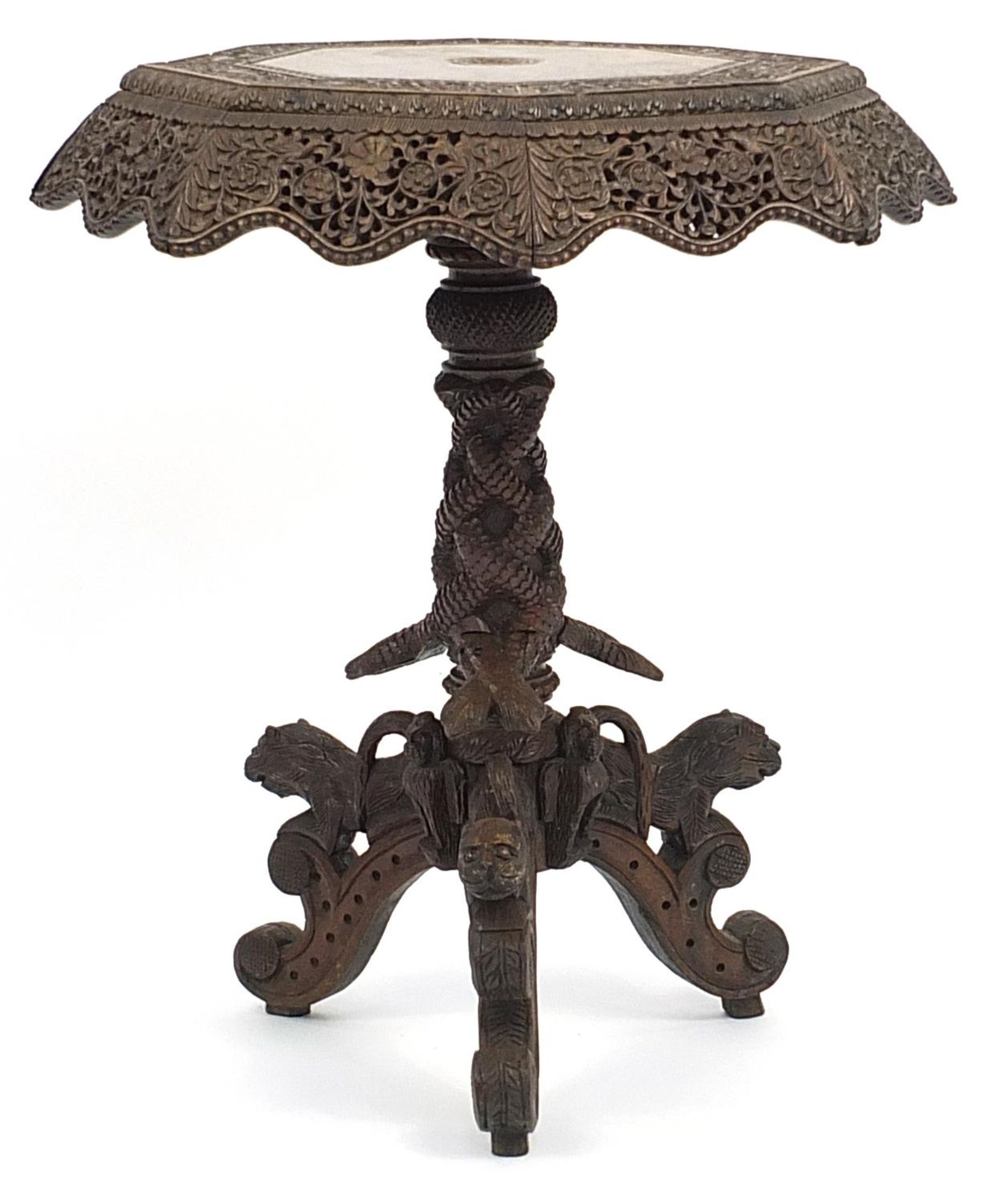 Burmese side table with octagonal top profusely carved with wild animals amongst flowers, with