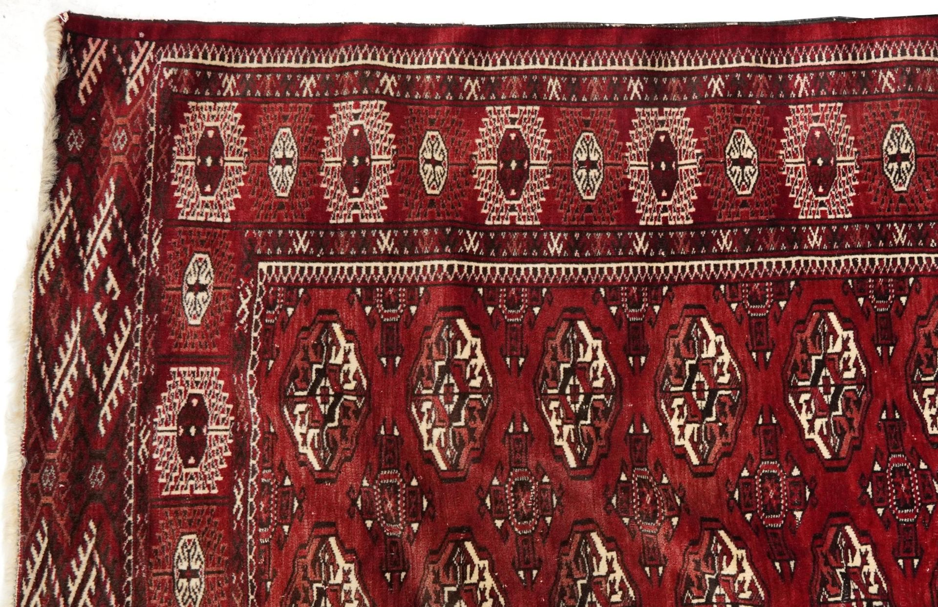 Rectangular Persian Turkmen red ground carpet having an all over geometric design, 345cm x 215cm - Image 2 of 8