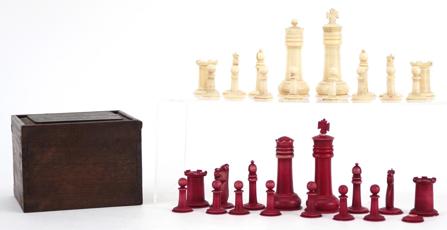 Half stained turned bone chess set, the largest piece 9cm high