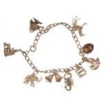 Silver charm bracelet with assorted silver charms including horse, dogs in a basket, elephant,