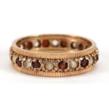 9ct gold white sapphire and garnet eternity ring, size Q/R, 3.7g