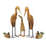Three novelty carved wood standing ducks and two hand painted wood duck decoys, the largest 52cm