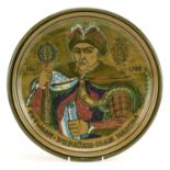 Russian Orthodox pottery charger hand painted with a gentleman with sceptre and scroll, 37.5cm in