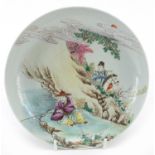 Chinese porcelain shallow dish hand painted in the famille rose palette with a fisherman beside