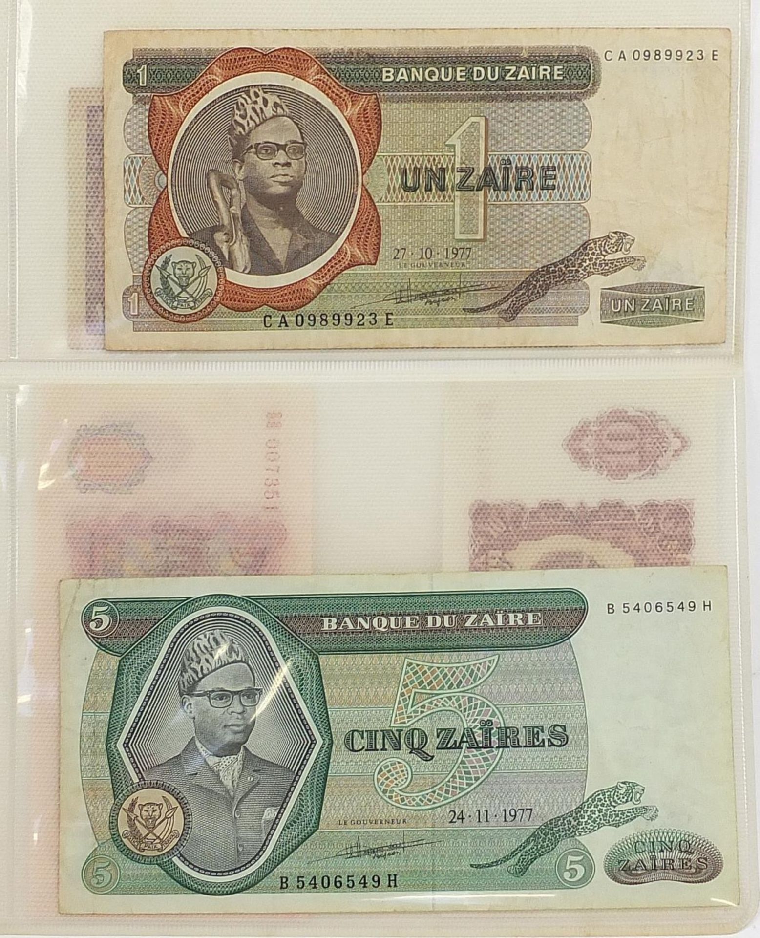 Collection of world banknotes arranged in an album including China and Brazil