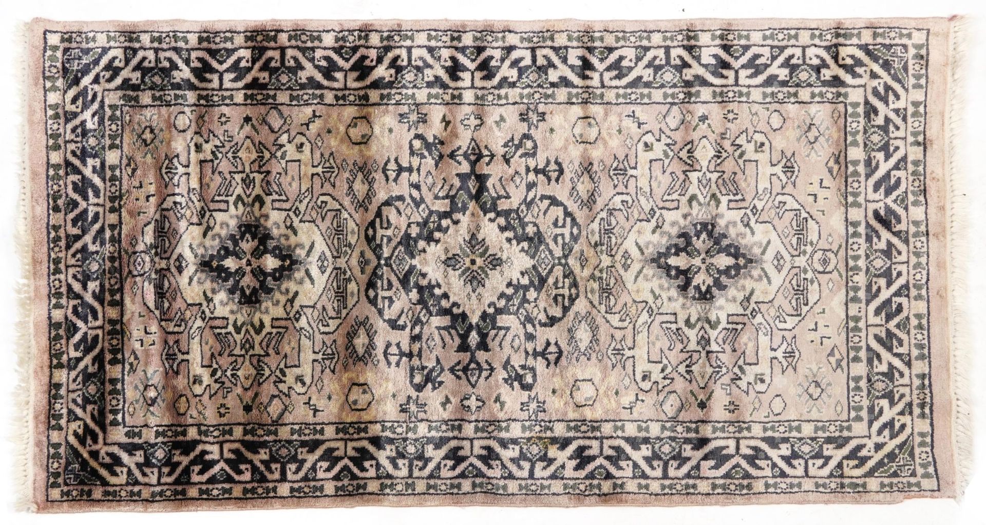 Rectangular pink and blue ground rug having an all over geometric design, 130cm x 75cm