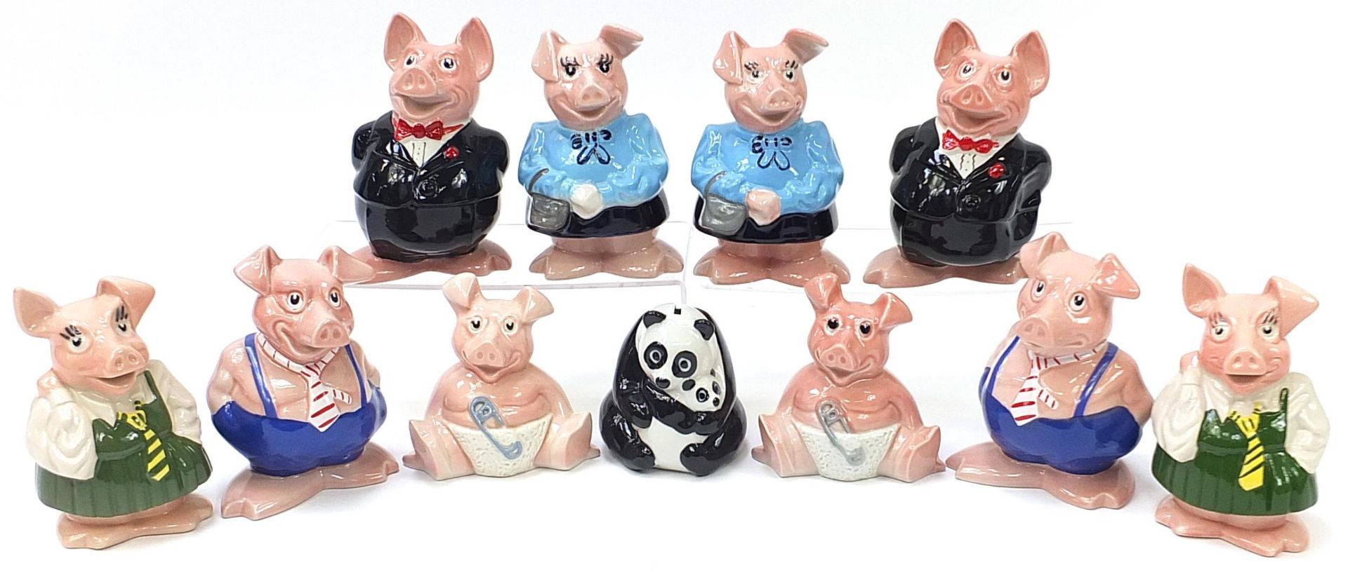 Two sets of five Wade Natwest pig money banks and panda money bank, the largest 19cm high