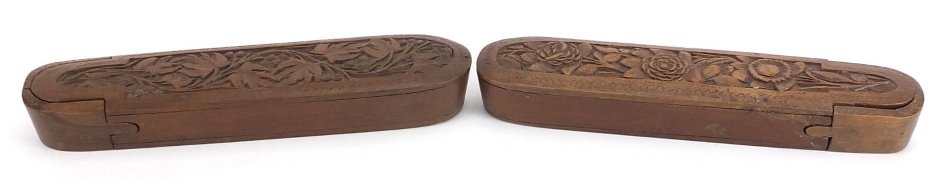 Pair of Islamic wooden pen boxes carved with leaves and flowers, each 24.5cm in length