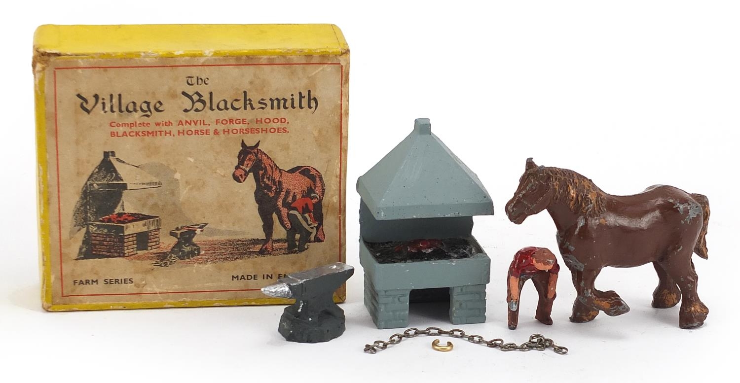 Vintage hand painted lead village blacksmith by Miniature Models number 169 with box, the horse