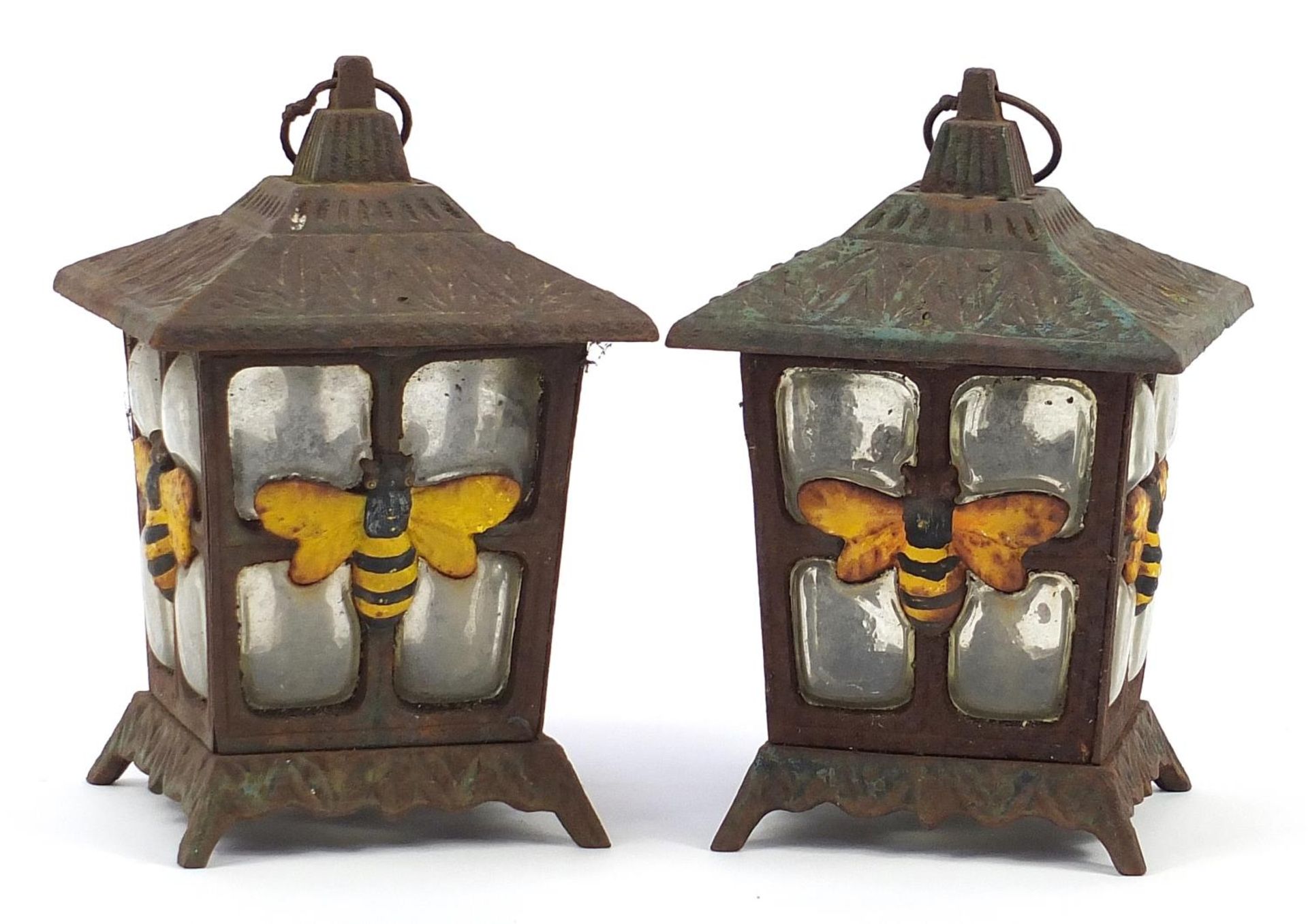 Pair of cast iron and glass garden tealight lanterns decorated with bumble bees, 23cm high