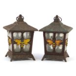 Pair of cast iron and glass garden tealight lanterns decorated with bumble bees, 23cm high