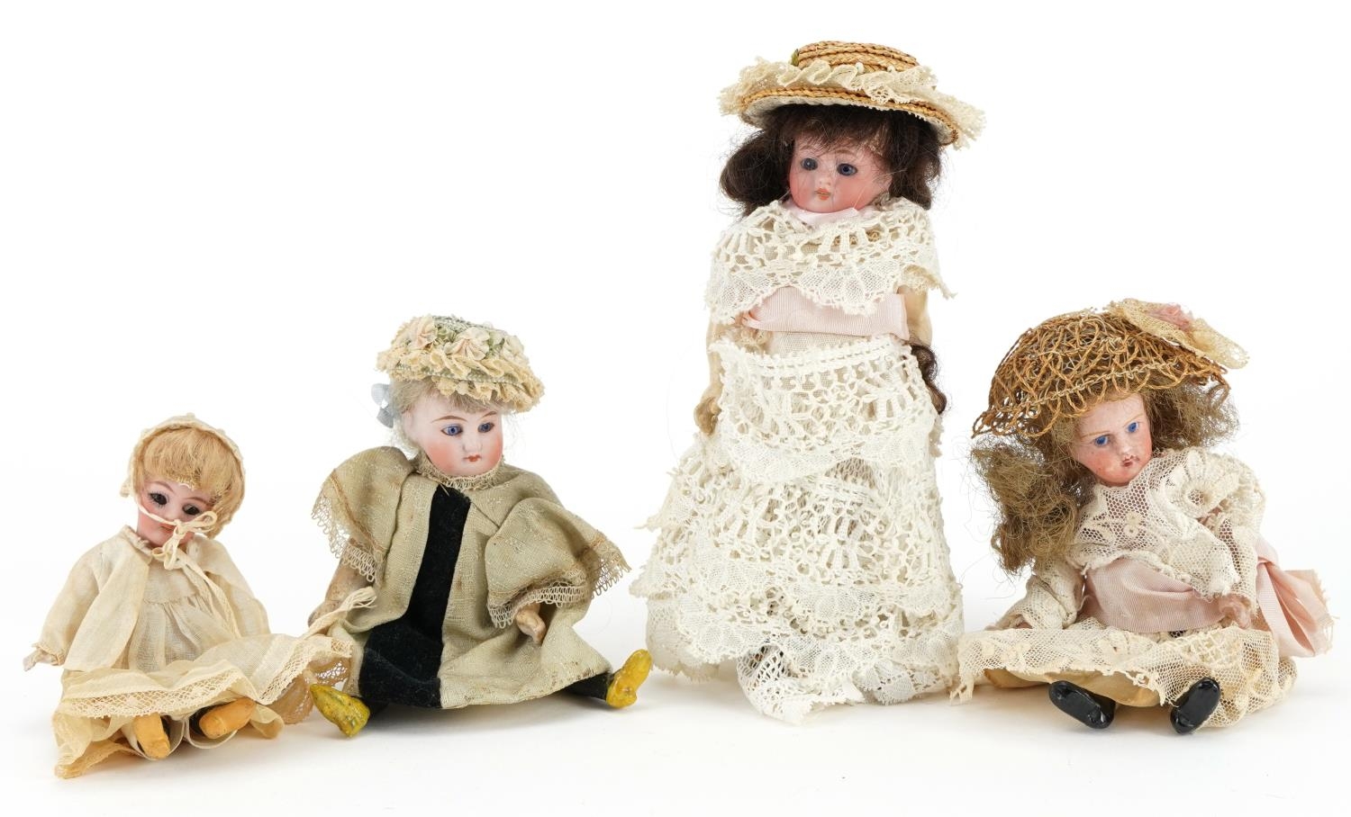 Four miniature bisque headed dolls, the largest 16cms high