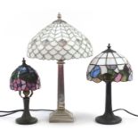 Three Tiffany style table lamps with leaded glass shades, the largest 50cm high