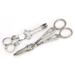 Henry Atkin, pair of silver grape scissors and a pair of silver sugar nips, indistinct hallmarks,