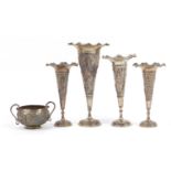 Four Indian white metal vases and sugar bowl with twin handles profusely embossed with deities,