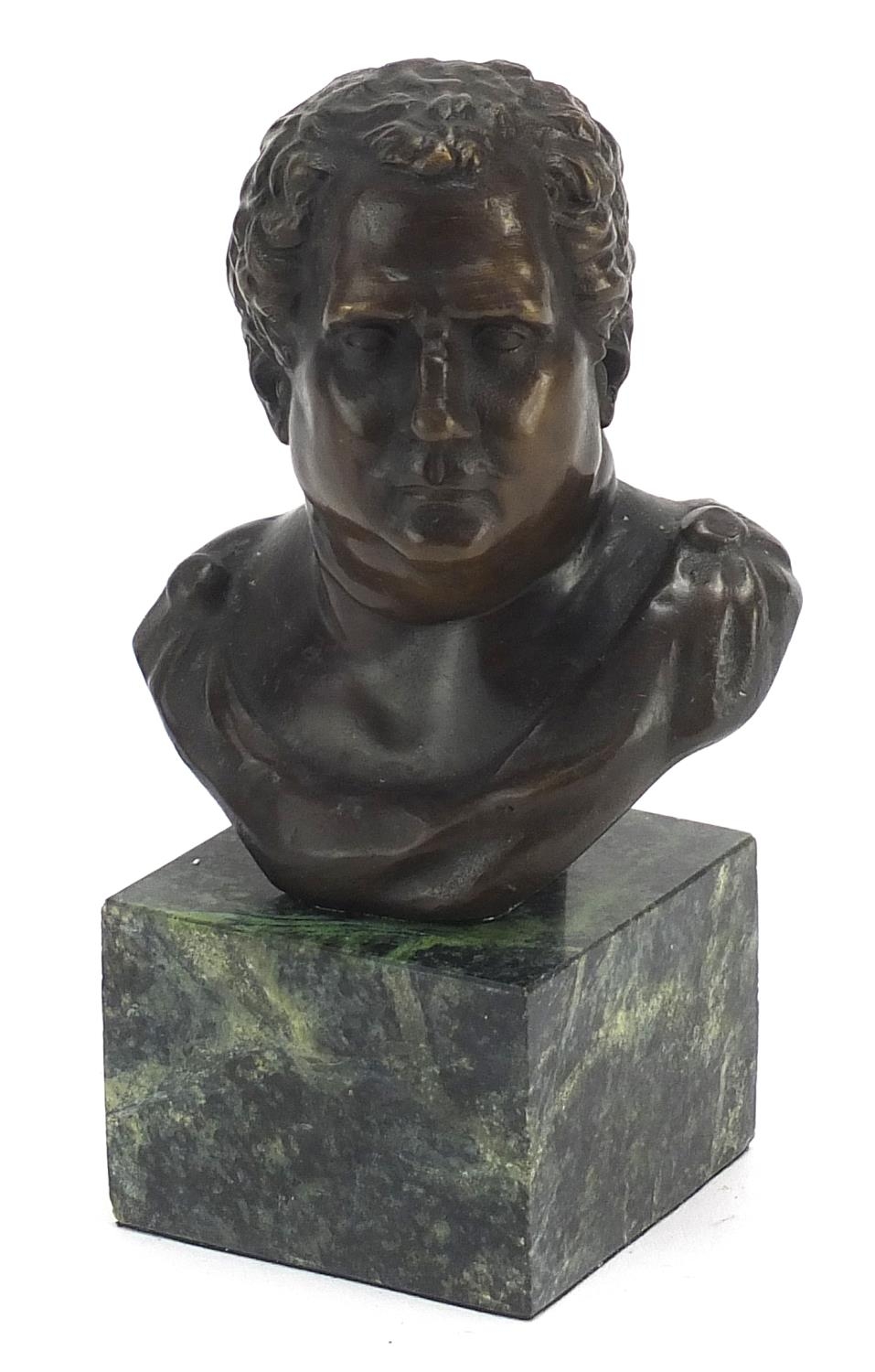 Patinated bronze bust of a Roman Emperor raised on a green marble base, 14cm high