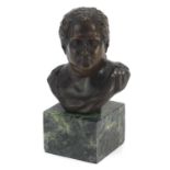 Patinated bronze bust of a Roman Emperor raised on a green marble base, 14cm high