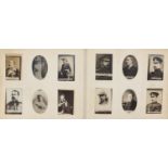 Collection of photographic cigarette cards arranged in albums including famous people