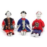 Three Chinese porcelain dolls with cloth bodies and tapestry clothing, the largest 41cm high