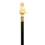 Hardwood walking stick with carved bone dog design pommel, 98cm in length