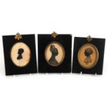 Three hand painted oval silhouettes including two of females in Georgian dress, each housed in