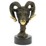 Partially gilt patinated bronze bust of a ram's head raised on a circular slate base, the bronze