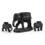 Three early 20th century black painted pottery lion design planters, the largest 21cm in length