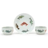 Two Chinese porcelain bowls and a saucer, each hand painted with fish, character marks to the bases,