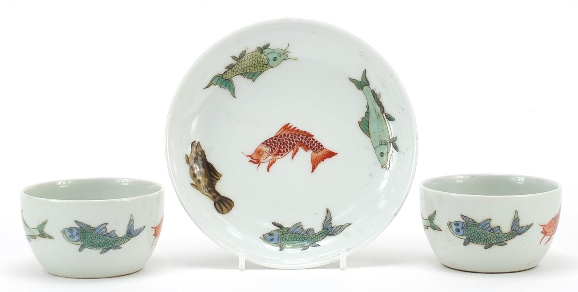 Two Chinese porcelain bowls and a saucer, each hand painted with fish, character marks to the bases,