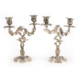 Pair of Rococo style silvered acanthus design two branch candelabras, each 26cm high