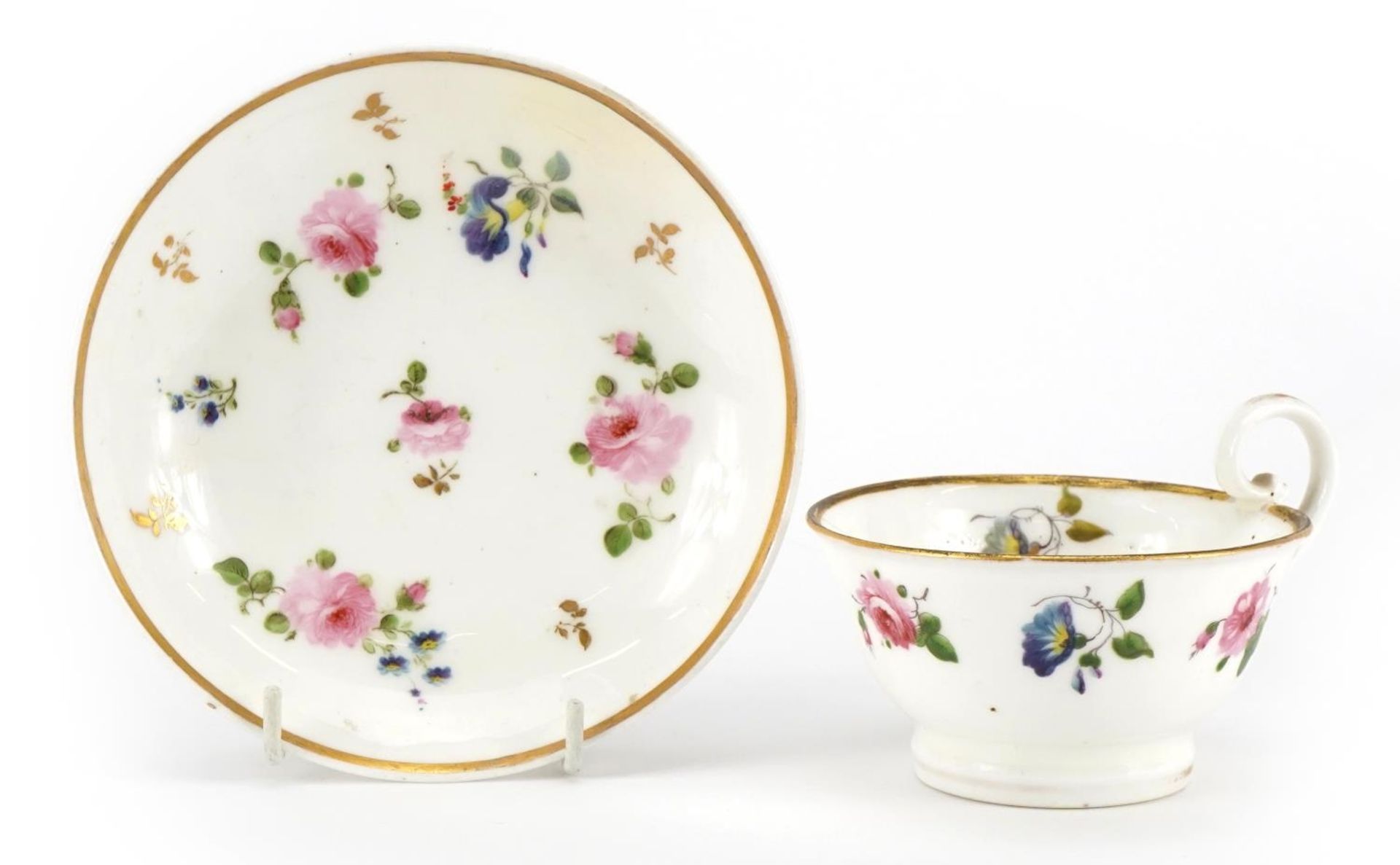 Early 19th century Nantgarw cup and saucer hand painted with flowers, the cup 5cm high