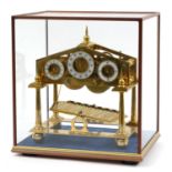 Gilt brass Congreve rolling ball clock with fusee movement and three chapter rings housed under a