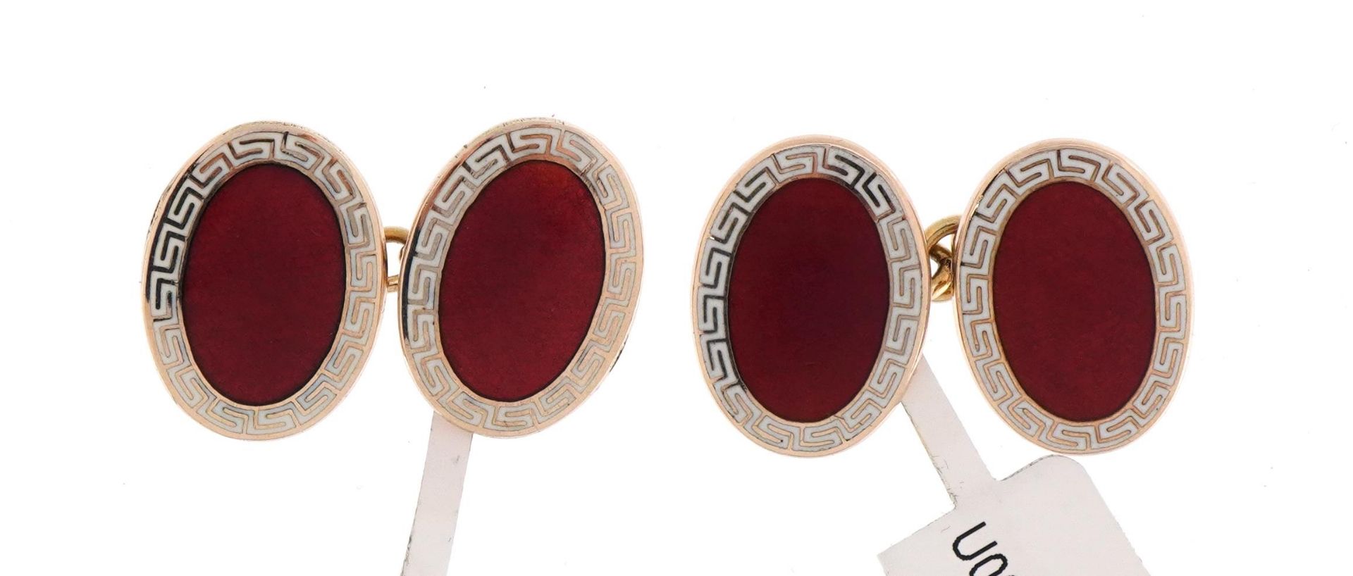 Pair of 9ct gold, red and white enamel cufflinks retailed by Asprey, housed in a Suttons & Robertson