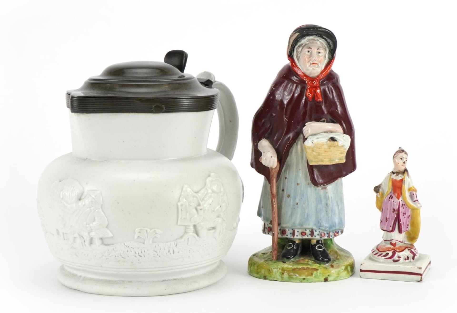 Early 19th century ceramics including a pearlware figure and stoneware jug with pewter mounts, the