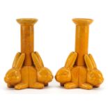 Manner of Christopher Dresser, pair of Arts & Crafts yellow glazed candlesticks with three