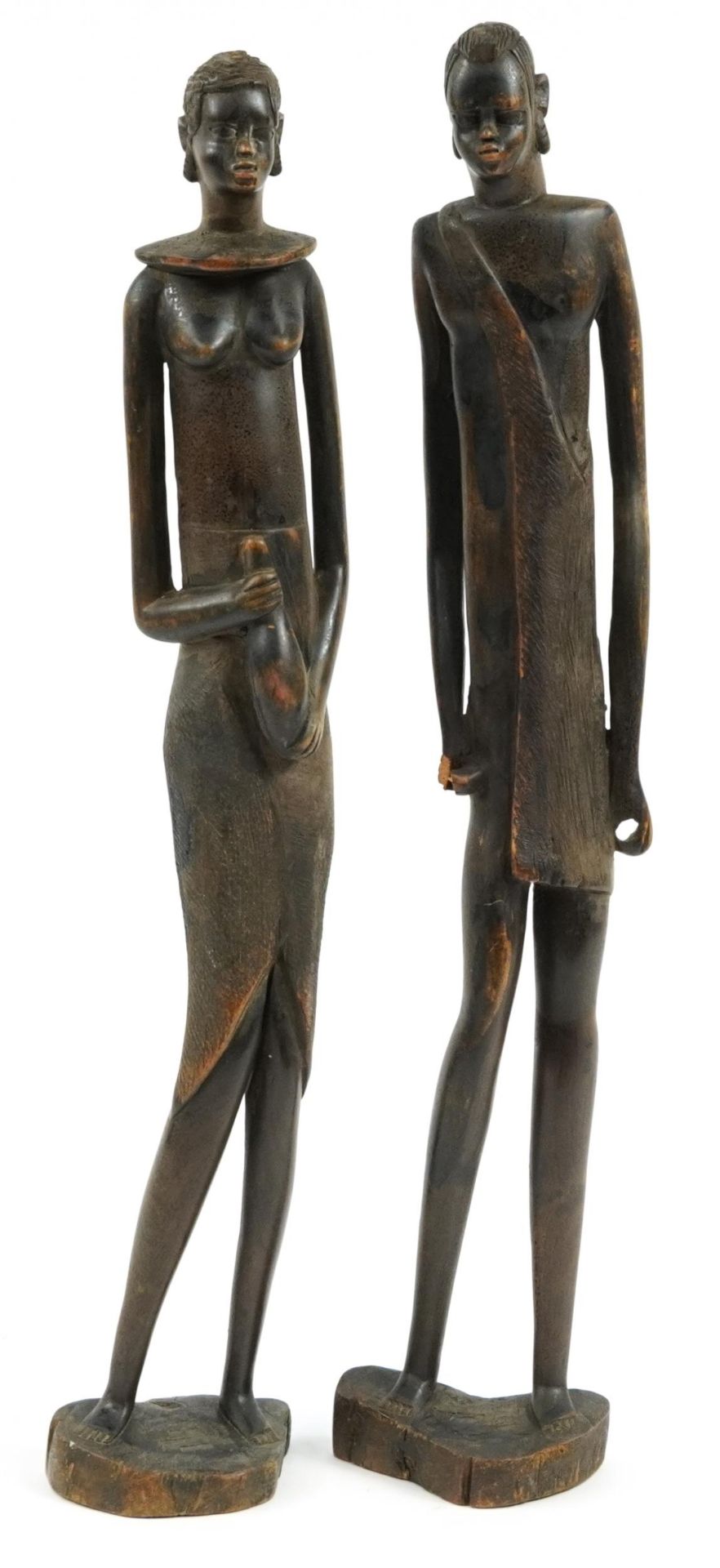 Pair of West African carved wood figures of a male and female, each 59cm high