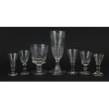 Seven antique glasses including an 18th century rummer with heraldic engraving, the largest 21cm